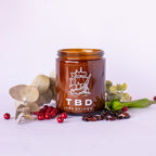 Brown jar with 'TBD Creatives' branding on a white background with decorative elements.