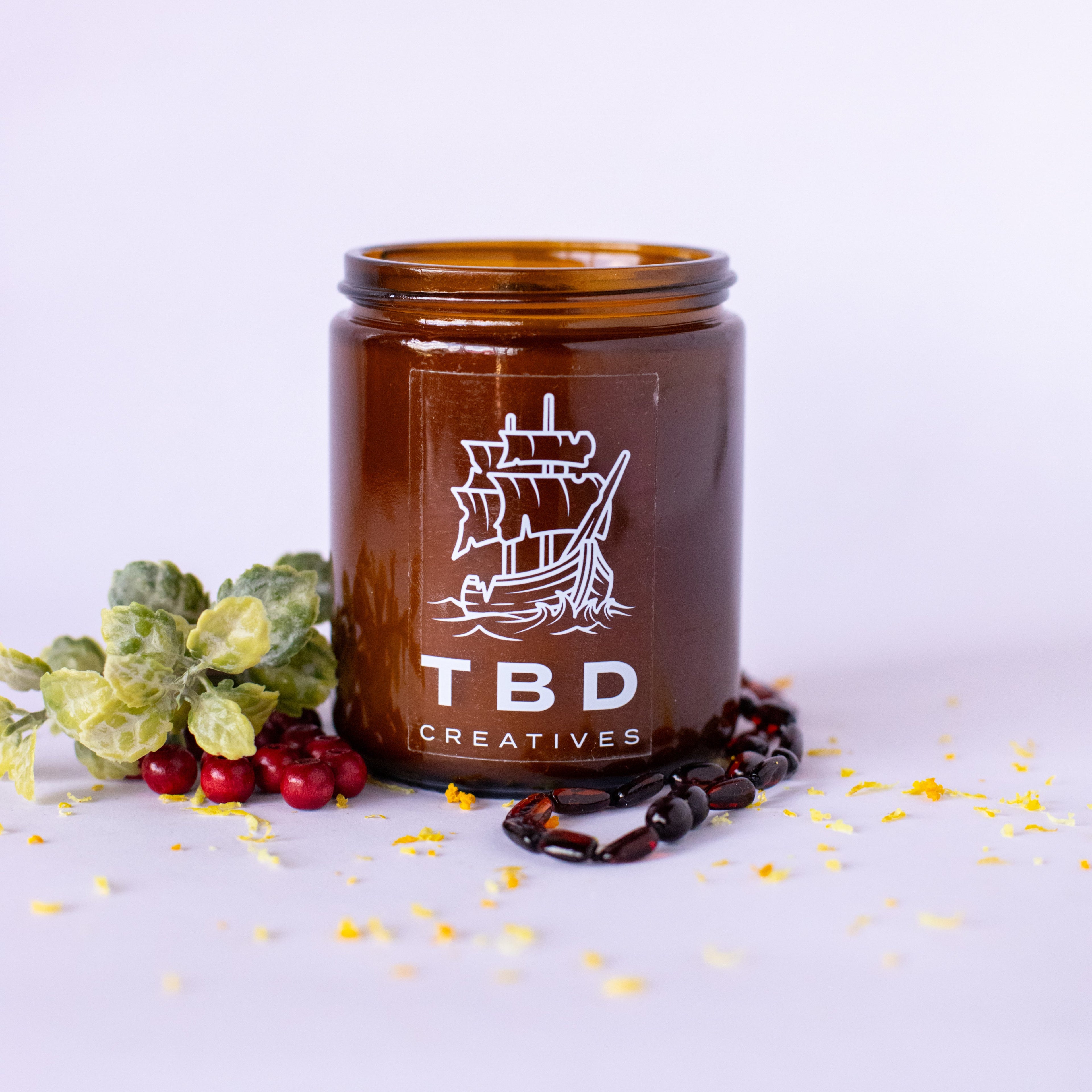 Brown jar with 'TBD Creatives' logo on a white background