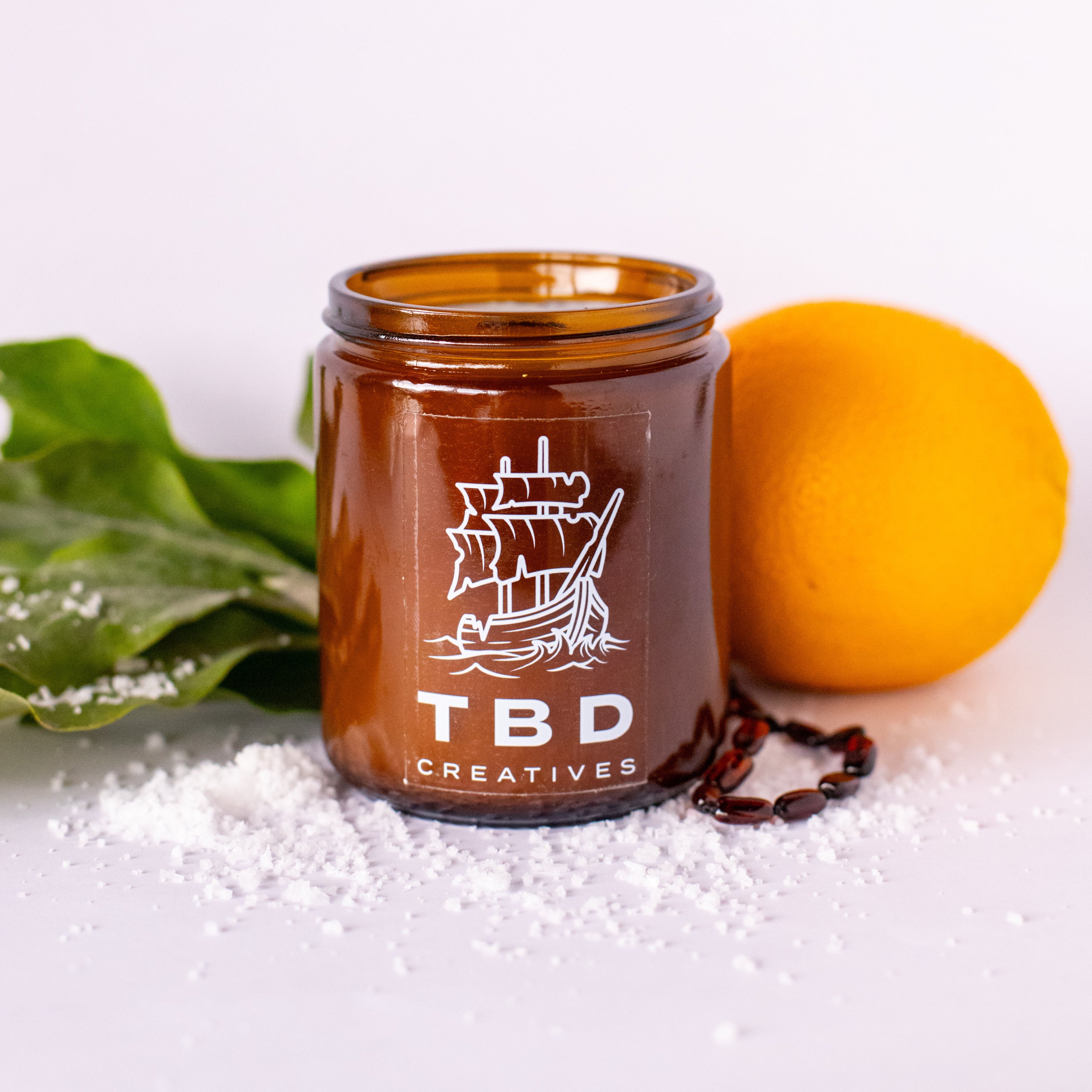 Brown jar with ship logo and 'TBD Creatives' text on a white background