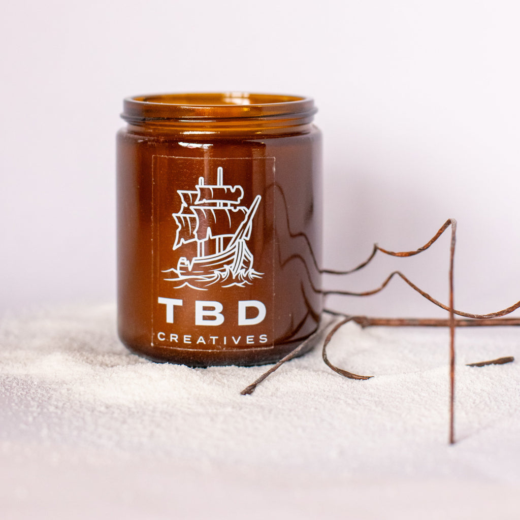 Brown jar with ship logo and 'TBD Creatives' text on a white background